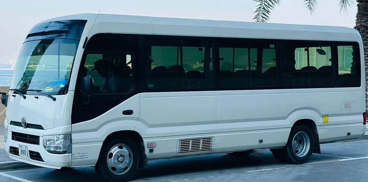 Captured left side: 30 Seater Workers Bus Toyota commonly seen in Private Group Trips across Ras Al Khaimah, praised for style